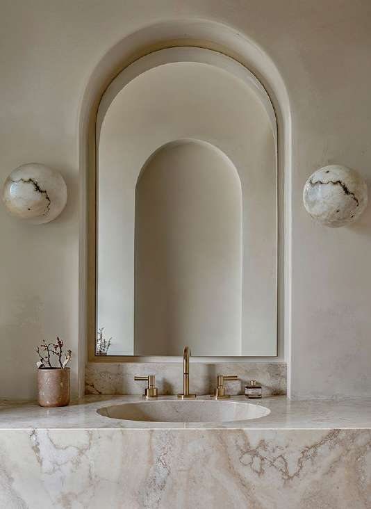 Stone washbasin beneath an arched niche
